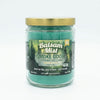A Candle by Smoke Odor Exterminator, featuring crisp scent notes of fresh balsam, bergamot, forest greens, and aromatic pine.