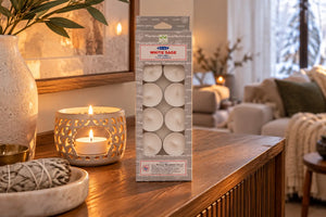 Energy clearing white sage satya tealiight candles on sideboard in clean home in the winter time. 
