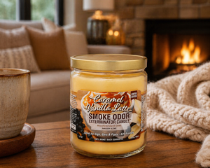 Caramel Vanilla Latte candle on a wooden table with a fireplace in the background