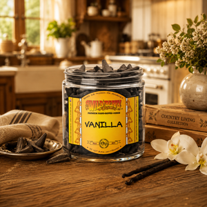 Jar of vanilla incense cones with a label on a wooden table in a kitchen setting.