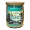 A Candle by Smoke Odor Exterminator, featuring crisp scent notes of fresh balsam, bergamot, forest greens, and aromatic pine.